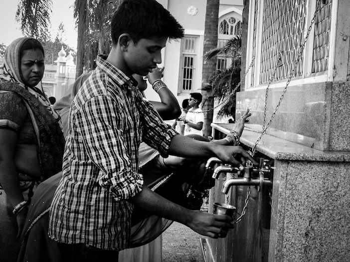 Des Indiens se servent d'eau en libre service dans les rues de Mysore.